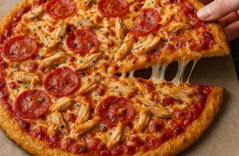 Canned chicken pizza crust recipe – crispy low carb keto pizza base topped with cheese and seasonings.